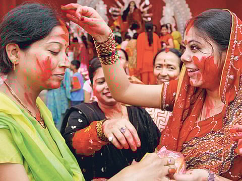 Hindu devotees smear each other with red vermilion as part of Vijaya Dashami rituals in Allahabad on Sunday. Vijaya Dashami, also known as Dasara or Dussehra, is the culmination of the Navratri festival and Durga Puja. 