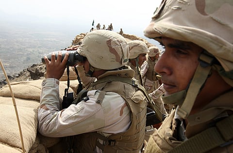 File picture: Saudi soldiers look out from Mt. Doud, a high strategic position in the southern Saudi province of Jizan, near the border with Yemen.