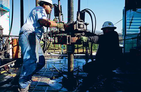 Drillers at a wellhead in Fort Worth, Texas. Latest forecasts show global oil demand lagging the corresponding 2019 levels.
