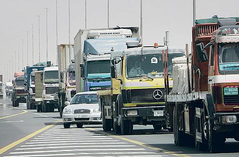 A car moves in between trucks and heavy vehicles on Shaikh Mohammad Bin Zayed Road in Dubai. 