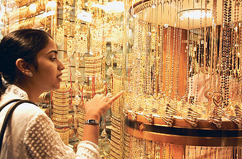 A shopper looks at the window display in a jewellery shop in the Gold Souk. For the first time, UAE’s jewellery retailers are using more of online portals to get people to buy gold on “Akshaya Trithiya”, the Indian festival when buying assets, especially the yellow metal, is deemed auspicious.