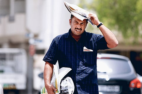 A man shields himself from the blistering sun using a newspaper. The southern parts of the country have experienced very high temperatures while people living in the coastal areas have faced an increase in humidity, especially during the afternoon. 