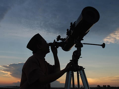 Archives: In this photograph taken on August 10, an official from the State Islamic University (STAIN), uses a telescope to observe the moon after sunset from the coast of Madura in East Java province of Indonesia on the eve of Ramadan. The exact dates of the start and the end of Islam's holy month Ramadan depend on the sighting of the new moon. 