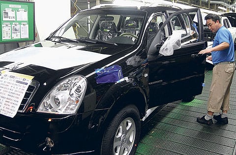 Employees of Ssangyong Motor work at the company's assembly line. Mahindra & Mahindra Ltd. is in discussions with an investor for selling a majority stake in Ssangyong Motor Co. 