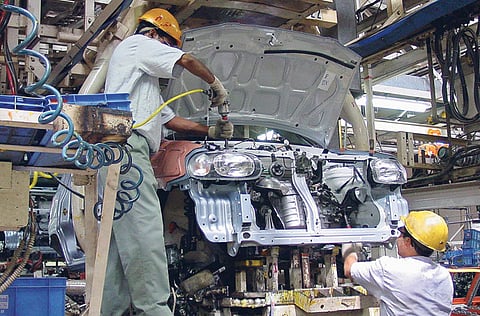 File photo: Maruti technicians work on the assembly line for the Suzuki-Maruti Alto compact car at their Gurgaon factory in Haryana. 