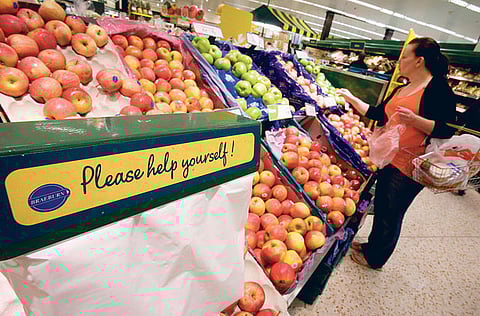 A customer at the fresh fruit section at a Morrison's supermarket in Grays, UnitedKingdom. Morrisons has agreed a takeover offer from Fortress Investment Group.