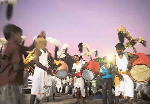 File picture: Traditional drummers perform outside a railway station as they wait to be hired for their services during Durga Puja in Kolkata on Saturday. The five-day festival commemorates the slaying of the demon king Mahishasur by the deity Durga.