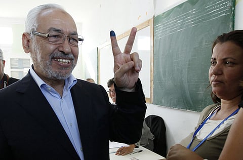 In this file picture, Rashid Ghannouchi, the head of the moderate Islamist Ennahda party, gestures after casting his vote at a polling station in Tunisia October 23, 2011.