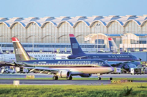 A US Airways Express jet lands at Ronald Reagan National Airport in Arlington, Virginia. Global  carriers are now expected to end 2021 offering about two-thirds the number of seats they did in 2019. Passenger demand could be even lower.