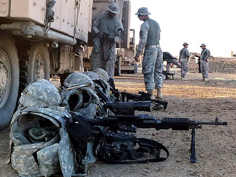 File photo: US soldiers prepare their gear prior to departing a base in Iskandariyah, south of Baghdad, on December 8, 2011. 
