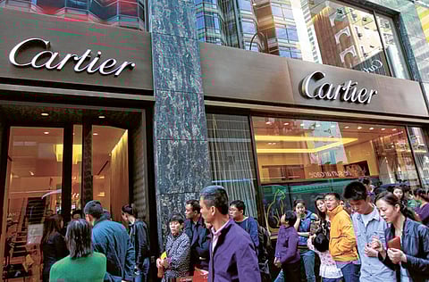 Shoppers from mainland China line up outside the Cartier luxury goods store as tourists enjoy their Chinese Lunar New Year holiday.