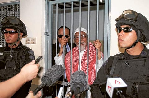 File picture: Radical cleric Abu Bakar Bashir (centre) behind bars in Indonesia. 