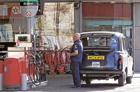 New fossil fuel powered cars will become history in the UK in 2032. File picture of a London taxi being refuelled at a Texaco petrol station. 