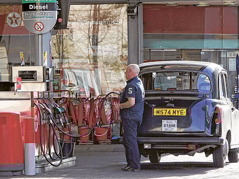 New fossil fuel powered cars will become history in the UK in 2032. File picture of a London taxi being refuelled at a Texaco petrol station. 