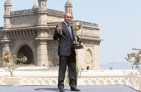 The morning after: A shaven-headed Mahendra Singh Dhoni poses with the ICC World Cup and the Man-of-the-Match award near the Gateway of India in Mumbai in 2011.