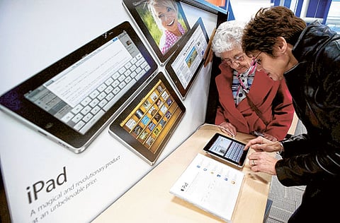 Carol Lidfeldt and her mother Evelyn DeSalvo test an Apple iPad computer. The showdown with Exxon fo