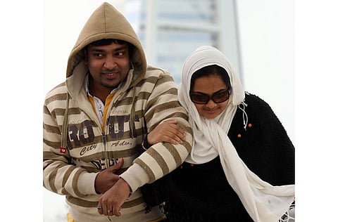 A young couple braves the cold weather in Dubai's Jumeirah beach.  