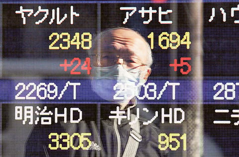 File picture of an electronic stock board at a securities firm in Tokyo. Memories of the Asian financial crisis of 1998 are being revived as debt loads mount for the continent's businesses. 