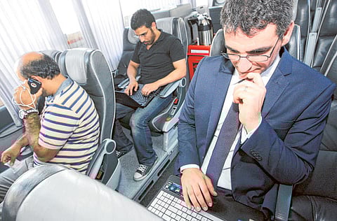 Passengers make use of the Wi-Fi facility in a bus operating between Dubai and Abu Dhabi.