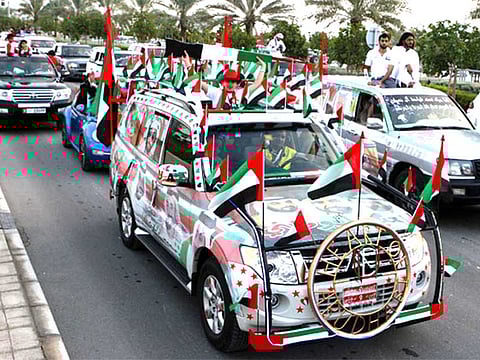 People participate in the Spirit of the Union Parade at Yas Island in Abu Dhabi to celebrate National Day of the UAE.