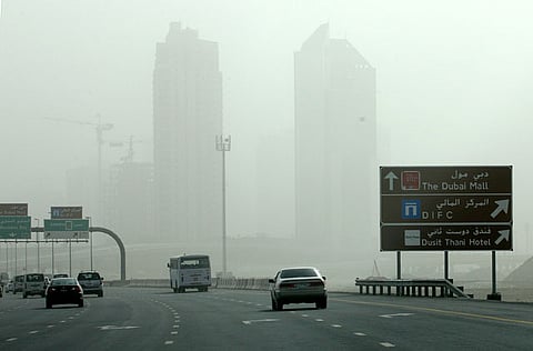 Motorists brave the sandstorm and low visibility on a Dubai road on Thursday afternoon. 