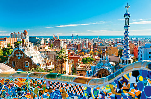 An aerial shot of Barcelona city overlooking Park Guell, one of the major works of Antoni Gaudí that opened in 1926.  