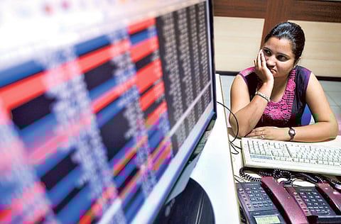 An investor watches the share index at a brokerage in Chandigarh, India