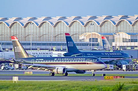 A US Airways Group Inc. Express Embraer 170 jet lands at Ronald Reagan National Airportin Arlington, Virginia, US. Berkshire Hathaway Inc sold its entire stakes in the four largest U.S. airlines in April, Chairman Warren Buffett said Saturday at the company’s annual meeting, saying “the world has changed” for the aviation industry. 