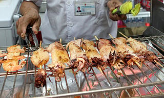 Sizzling skewers and neon lights: Get a street food fix with these perfectly grilled squids packed with smoky, savoury flavour  at Dubai's Global Village.
