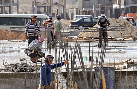 Foreign labourers work at a construction site in the Saudi capital Riyadh.