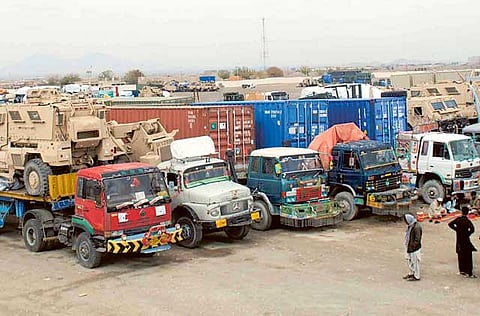 Trucks transporting NATO military vehicles destined for the port city of Karachi cross into Pakistan near the Afghan border in Chaman, Pakistan, 25 November 2013. 