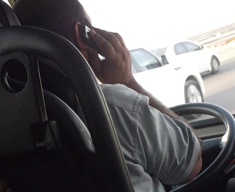 Bus driver caught on phone while driving