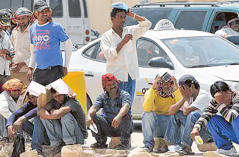 Labourers wait outside Saudi immigration offices, west of Riyadh. The kingdom is proceeding with efforts to reduce the unemployment rate to less than 7 per cent by 2030.