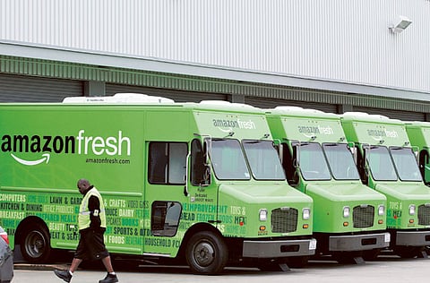 Delivery vans parked at an Amazon Fresh warehouse in Inglewood, California. The company believes the new Prime Fresh service will get people shopping for groceries and other everyday items more frequently from its website.