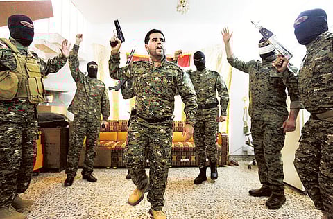 File picture shows fighters from Shiite militias in Iraq celebrating before leaving Baghdad for Syria. 