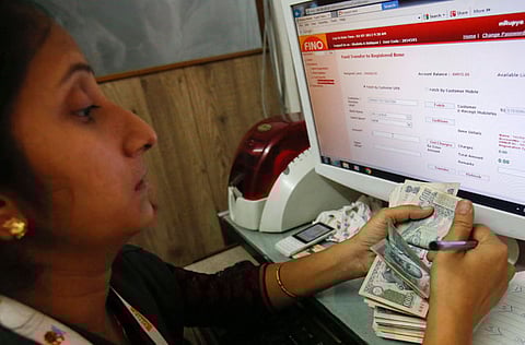 A teller counts a bundle of Indian Rupee currency notes. The rupee fell to a six-month low of 72.27 against the greenback compared to its previous close of 71.56 and closed at 72.17 against the US dollar, after trading in the range of 71.81 to 72.27 on Friday. 