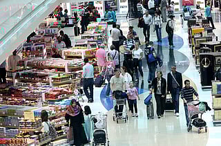 Passengers shop at Dubai Duty Free, Dubai International Airport.