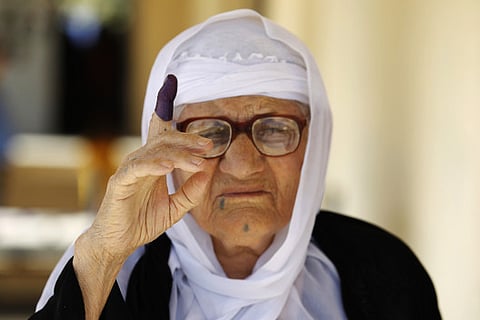 An Iraqi woman shows her ink-stained finger after casting her vote (File)