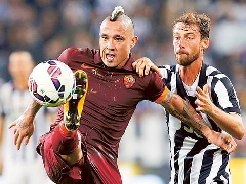 Juventus’ Claudio Marchisio (right) fights for the ball with Roma’s Radja Nainggolan.