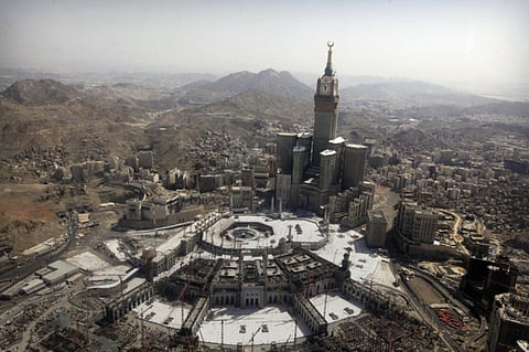 The tallest clock tower in the world with the world's largest clock face at the Abraj Al-Bait Towers overlooks the Grand Mosque and its expansion in Mecca, Saudi Arabia. 
