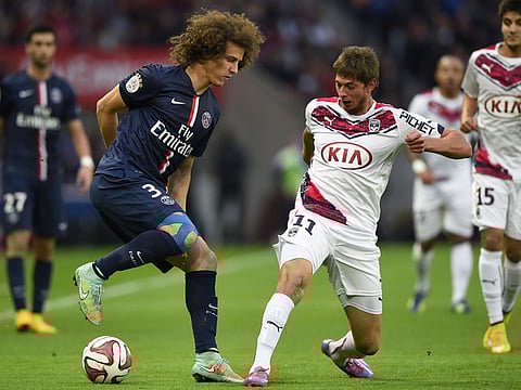 Paris Saint-Germain's Brazilian defender David Luiz (L) vies with Bordeaux's Italian Argentinian forward Emiliano Sala during the French L1 football match between Paris Saint-Germain (PSG) and Bordeaux (FCGB), at the Parc des Princes stadium in Paris on October 25, 2014.  