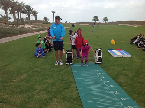 Tee and fun with kids at Saadiyat