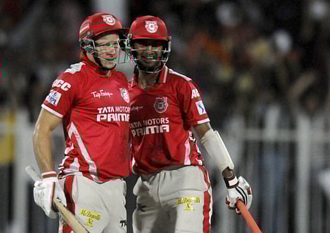 Cheteshwar Pujara (right), then with Kings X1 Punjab, celebrates a win with teammate David Miller during IPL 2014 in the UAE.