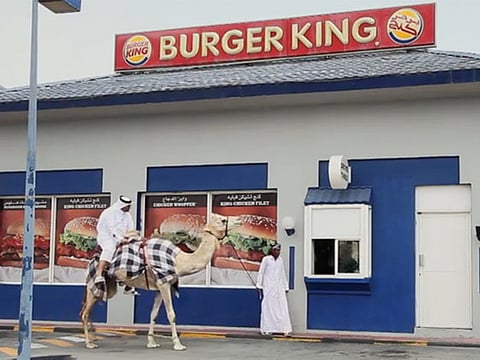Hungry man visits Qatar Burger King drive-through on camel