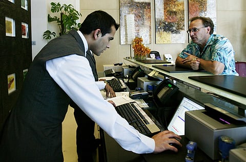 A customer at the front desk of a hotel on Shaikh Zayed road.