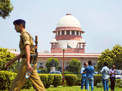 A security personel walks in front of the Indian Supreme court in New Delhi on August 27, 2014.
India’s top court said lawmakers with criminal backgrounds should not serve in government,