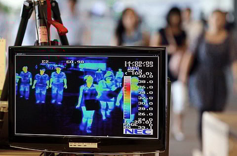 A thermal camera monitor shows the body temperature of passengers arriving from overseas against possible infections of Ebola virus at the Incheon International Airport in Incheon, South Korea, Friday, Aug. 8, 2014. South Korea has been stepping up monitoring of its citizens returning from trips to West Africa and other areas affected by the deadly Ebola virus.  
