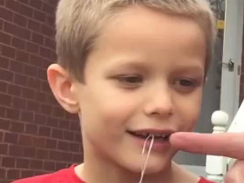Watch dad pull out son's tooth by hitting golf ball attached to piece of string