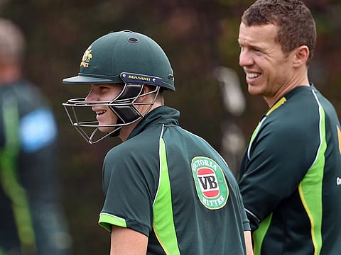 Australia's Peter Siddle with Steve Smith.