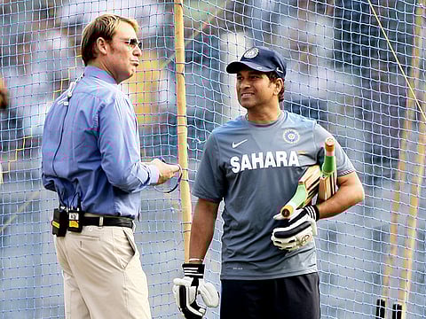 Sachin Tendulkar speaks to Shane Warne, in a TV pundit's role, during the former's farewell Test match in Mumbai in 2013.